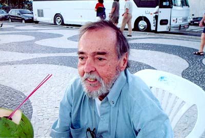 Orestes Polverelli tomando agua de côco na praia.